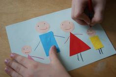 a child's hand drawing on paper with crayons