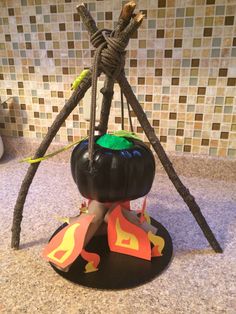 a halloween decoration made out of pumpkins and sticks