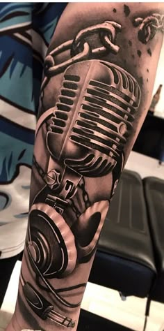 a man with a microphone tattoo on his arm