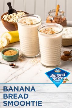 banana bread smoothie in two glasses with cinnamon on the side and other ingredients around it