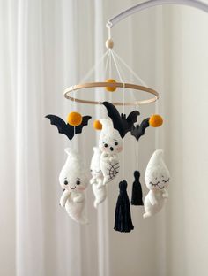 a crocheted mobile with stuffed animals hanging from it's sides and bats on them