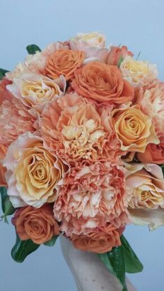 a bridal bouquet with orange and pink flowers