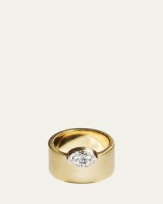 a gold ring with a diamond on top