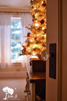 a white christmas tree in the corner of a room