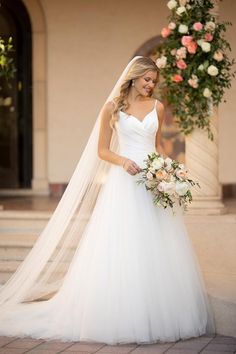 a woman in a wedding dress holding a bouquet