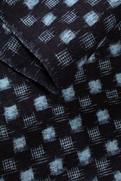 a black and white checkered fabric with small squares on the top, as if it were woven into something else