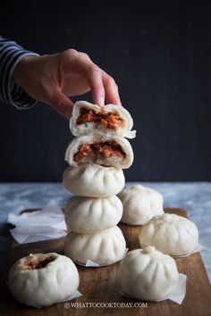 a person is stacking dumplings on top of each other