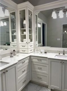 a large bathroom with two sinks and mirrors