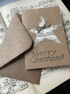 two christmas cards on top of sheet music