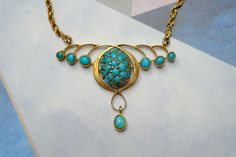 "STORY --------- Crafted in 9 carat gold, this vintage Art Nouveau style necklace features a pretty organic floral pendant section inset with natural green & blue turquoise, and is fastened with a gold rope twist chain and bolt ring. Despite some age related wear, it remains wearable today... SPECIFICS -------------- Metal: 9 carat gold (tested, hallmark illegible) Stones: Turquoise Dimensions: 15.5\" long Condition Notes & Care: Overall in expected vintage condition with some minor denting, wea Turquoise Locket Jewelry For Wedding, Turquoise Locket For Wedding Jewelry, Turquoise Wedding Locket Jewelry, Elegant Turquoise Locket Jewelry, Victorian Turquoise Gemstone Jewelry, Elegant Turquoise Locket Necklace, Vintage Yellow Gold Cabochon Necklace, Turquoise Vintage Jewelry With Vintage Charm, Vintage Turquoise Necklace As A Gift