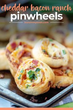 bacon ranch pinwheels on a baking sheet with text overlay that reads, cheddar bacon ranch pinwheels