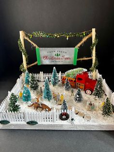 a christmas village with trees and animals in the snow