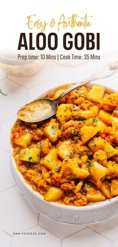 an image of aloo gobi in a bowl with spoons on the side