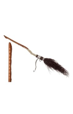 an old wooden stick with a feather on it's end and a long handle