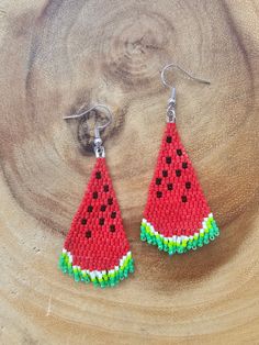 a pair of watermelon seed beaded earrings