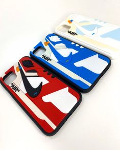 three cases with different designs on them sitting next to each other in front of a white background