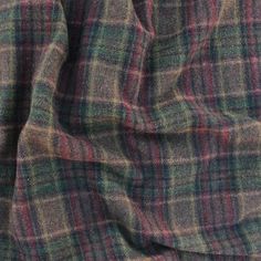 a close up view of the fabric on a plaid shirting material that is red, green and blue