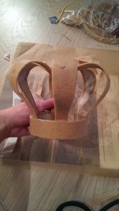 someone is making a paper crown out of cardboard