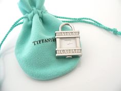 Offered for sale is a super cool and rare Tiffany & Co. Atlas Roman Numeral Swiss Made Watch Padlock Charm ! The piece is super cool, practical / useful at the same time! It has a fully working Swiss Made mechanism shaped into a cool and Classic Tiffany & Co. Padlock Charm! The padlock charm opens and closes and can easily be attached to an existing necklace or charm bracelet! Awesome gift for the traveler and/or Tiffany collector in your life! As always, the item is hallmarked and guaranteed to Interlocking Circle Necklace, Silver Link Necklace, Tiffany And Co Necklace, Cupcake Charms, Watch Clock, Bamboo Earrings, Toggle Necklace, Roman Numeral, Pink Enamel