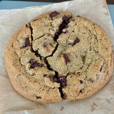 a chocolate chip cookie sitting on top of a piece of paper