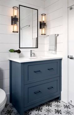 a bathroom vanity with two mirrors above it