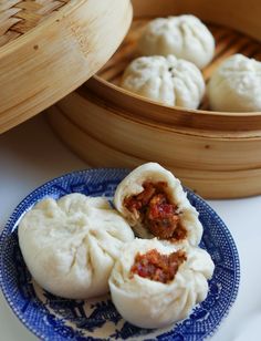 some dumplings are sitting on a blue and white plate