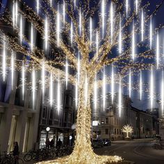 a lighted tree in the middle of a street