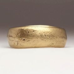 The rustic and irregular nature of our sandcast range comes from Justin's own technique; as the name suggests each ring is cast in sand. With a different mould used each time, every ring is totally unique - make it that little bit more special by sending us your own sand.  Chunky, handmade sand cast ring in 9ct yellow gold. This ring is made by casting recycled gold in beach sand. It has a really lovely chunky feel and the 9ct yellow gold has a lovely sandy colour. The sand mould creates the tex Luxury Hand Forged Rings In Recycled Gold, Luxury Recycled Gold Hand Forged Rings, Luxury Hand Cast White Gold Rings, Luxury Yellow Gold Engraved Ring In Recycled Material, Luxury Engraved Yellow Gold Ring In Recycled Material, Luxury Hand Cast Rings For Formal Occasions, Luxury Recycled Gold Ring With Polished Finish, Wedding Ring With Sand, Irregular Gold Rings