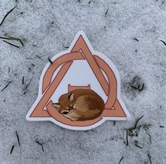 a sticker with an image of a deer laying in the snow