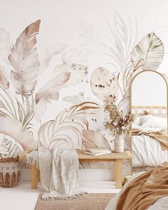 a bedroom with a bed, mirror and wallpaper that has tropical leaves on it