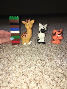 small toy animals are lined up on the floor