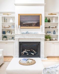 a living room filled with furniture and a fire place in front of a painting on the wall