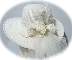 "This ivory summer bridal sun hat with a Victorian flair is covered in delicate lace appliques with pearl, rhinestone and sequin accents...just beautiful! Ivory Venice lace with crystal seed beads is the hat band. Ivory silk ribbon falls in long tails in back along with ivory crushed tulle that forms a soft bow with long tails. Ivory silk roses & vintage velvet leaves along with a rhinestone jewel & curled ostrich plumes fill the bouquet in back. Ivory satin braid finishes the edge of th White Brimmed Sun Hat For Wedding, Brimmed Cream Sun Hat For Wedding, Cream Sun Hat For Wedding At Royal Ascot, Cream Brimmed Sun Hat For Wedding, Adjustable Cream Sun Hat For Wedding, White Hat For Kentucky Derby, Mother Of The Bride, White Curved Brim Sun Hat For Wedding, Lace Wedding Hat, White Wedding Sun Hat With Curved Brim