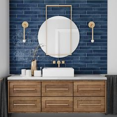 a bathroom vanity with two sinks and a mirror on the wall above it, in front of a blue brick wall