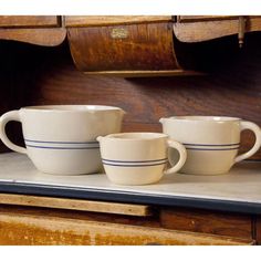 three coffee cups sitting on top of a counter