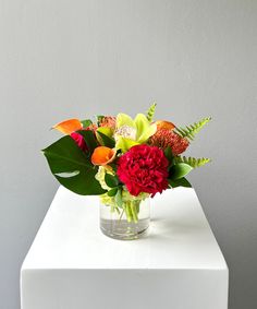 a vase filled with flowers on top of a white table