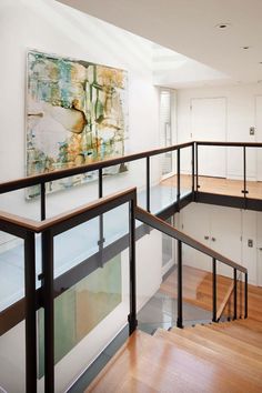 an open staircase leading up to the second floor in a modern home with white walls and wood floors