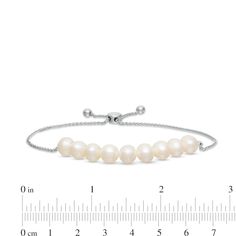 Grace her wardrobe with the sophisticated style of this four-piece pearl set. Fashioned in sterling silver, the necklace features a strand of 6.5-7.0mm freshwater cultured pearls that measures 18.0 inches in length and secures with a filigree clasp. The bolo bracelet features 6.5-7.0mm freshwater cultured pearls centered along a wheat chain, adjustable to 9.0 inches in length, that secures with a bolo clasp. The 6.0-6.5mm button-shaped freshwater cultured pearl and petite round lab-created white Elegant Adjustable Bracelet With Pearl Pendant, Elegant Adjustable Bracelets With Pearl Pendant, Single Strand Jewelry For Anniversary, Elegant White Pearl Bracelet With Adjustable Chain, Luxury Sterling Silver Pearl Bracelet For Formal Occasions, Formal Sterling Silver Pearl Necklace With Adjustable Chain, Fine Jewelry Pearl Drop With Round Beads, Formal Pearl White Bracelet With Pearl Pendant, Timeless White Gold Pearl Bracelet For Anniversary