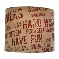 a lampshade with words written on it in red and beige colors, hanging from the ceiling