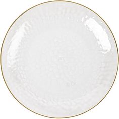 a white plate with gold trimmings on the rim and bottom, against a white background