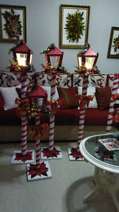 a living room decorated for christmas with red and white striped decorations on the couches