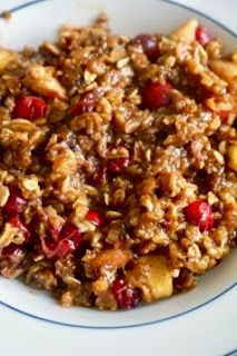 a white plate topped with granola and cranberries