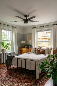 a bedroom with a bed, dresser and window in it's centerpieces