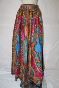 "African clothing are best known for their bold, unique and friendly colours. This maxi skirt is handmade  with our lovely  polarizing fabric Dashiki or Angelina as some call it. This is a nice long maxi skirt , gathered waist, fully lined , back zip fastening with two buttons as well.FEATHERS Cotton fabric Full maxi skirt Fully lined Under neat Gathered waist Back zip fastening and two buttons This fabric comes in so many vibrant colours, like blue, pink, orange. yellow ,purple and so on. We ca Bohemian Pink Maxi Bottoms, Pink Bohemian Maxi Bottoms, Pink Bohemian Maxi Length Bottoms, Pink Maxi Bottoms For Vacation, Multicolor Harem Skirt, Beach Multicolor Printed Skirt, Traditional Multicolor Maxi Skirt, Multicolor Printed Long Skirt, Bohemian Multicolor Skirt With Elastic Waistband