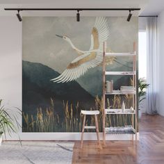 a painting of a bird flying in the sky with mountains behind it wall mural print