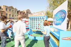 several people are playing an interactive game in the park