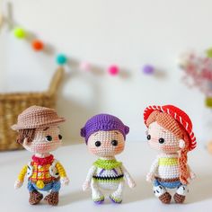 three small crocheted dolls are standing next to each other