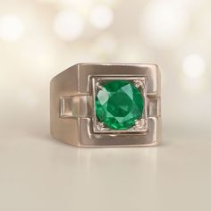 a ring with a large green stone in the center