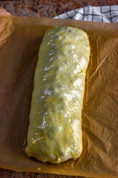 a piece of bread sitting on top of wax paper