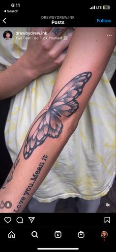 a person with a butterfly tattoo on their arm